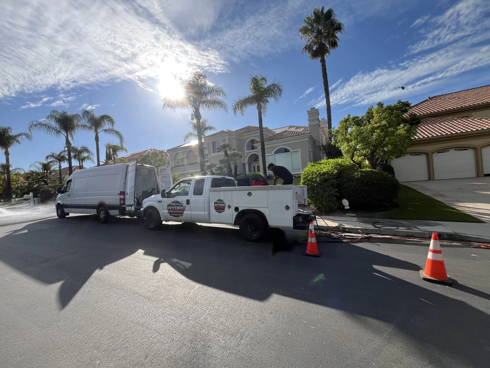 Parked service truck and van at a residential plumbing project